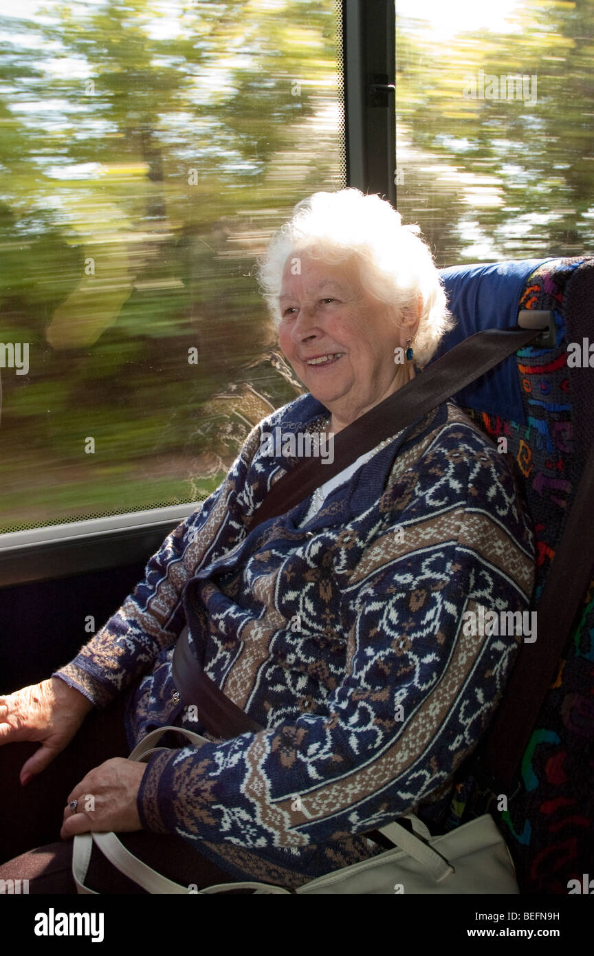 one female Elderly Passengers seated in a coach wearing seat belts Stock Photo Alamy