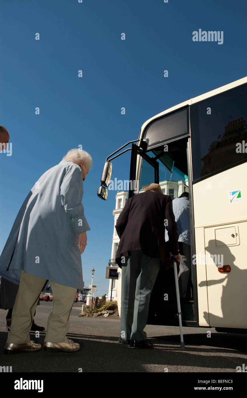 low angle view of senior, elderly and disabled people boarding a coach
