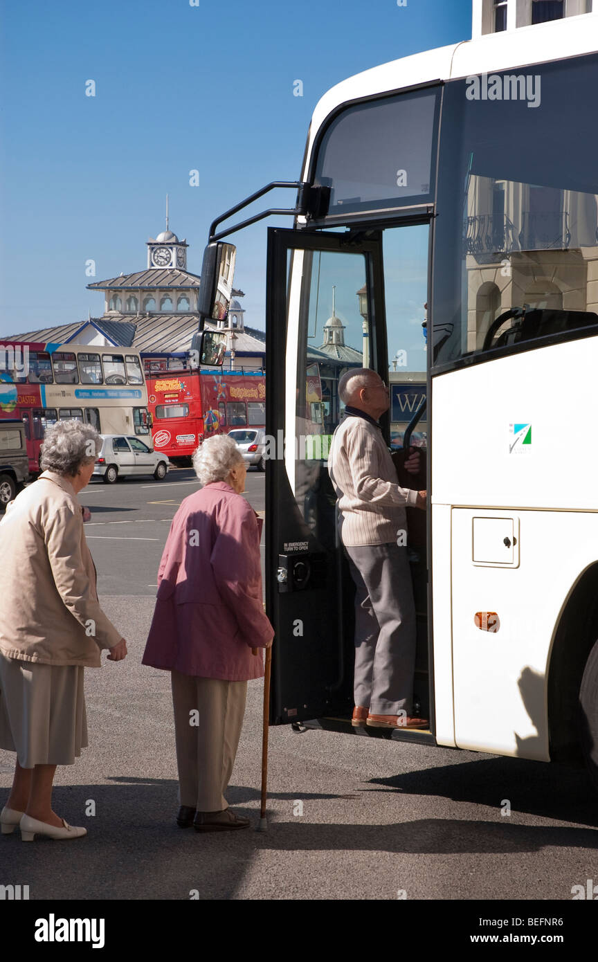 senior, elderly and disabled people boarding a coach on holiday Stock