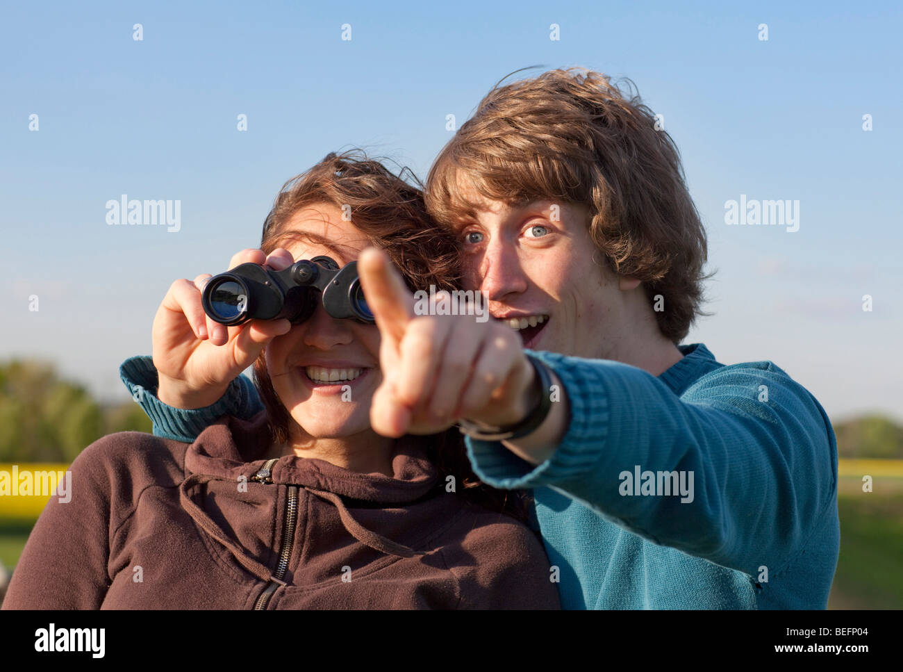 Couple using binoculars Stock Photo