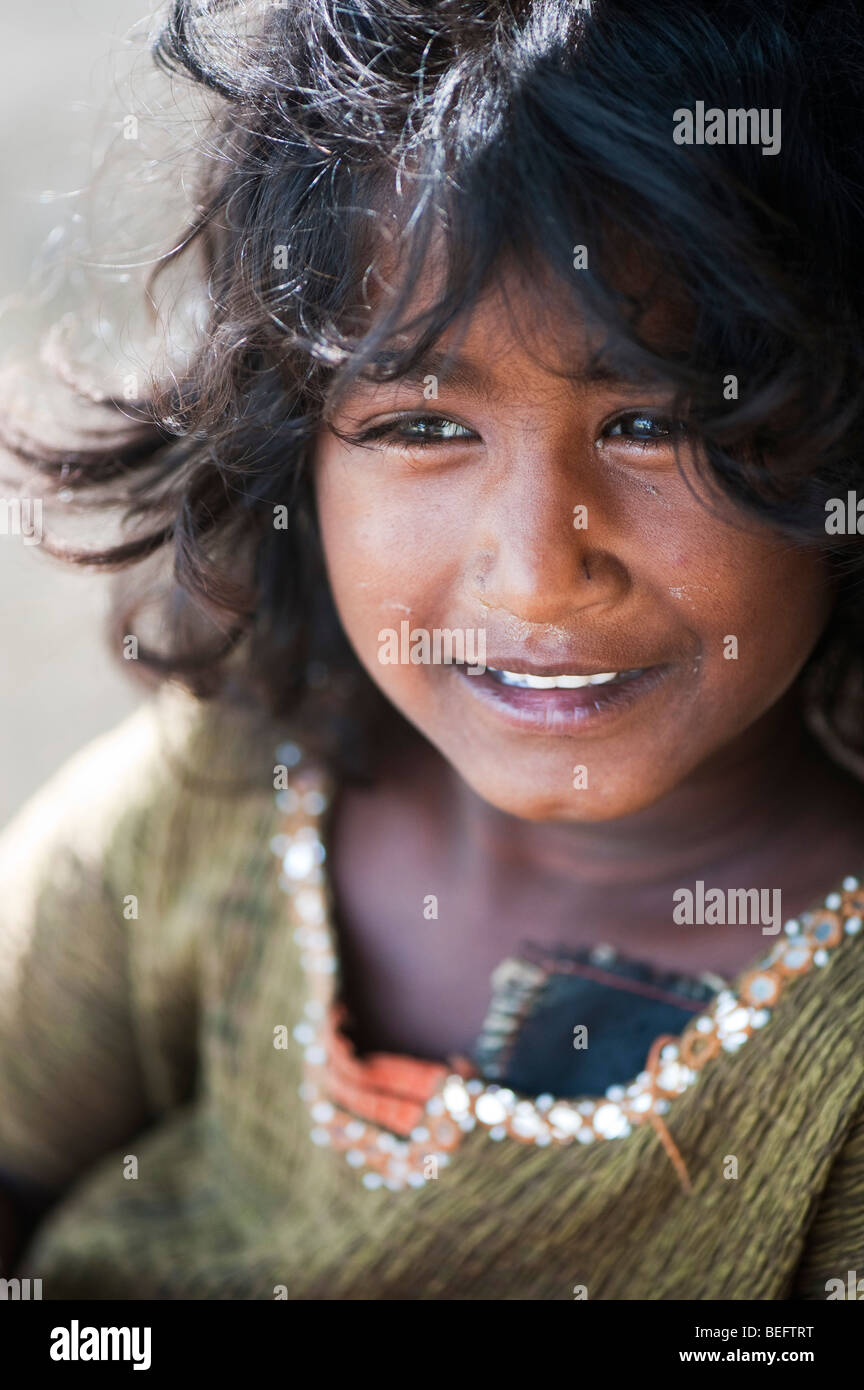 Happy young poor Indian street girl smiling. Selective focus Stock Photo