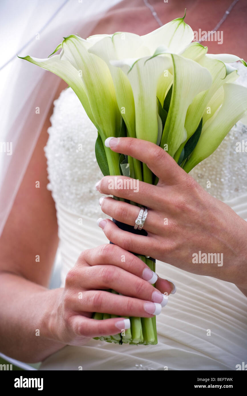 abstract selective focus image of bride holding flowers Stock Photo
