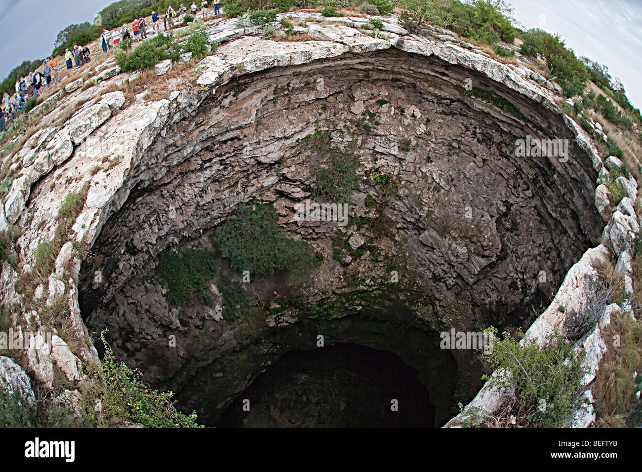 The Devil's Sinkhole Texas USA with people gathered to view bat flight Stock Photo