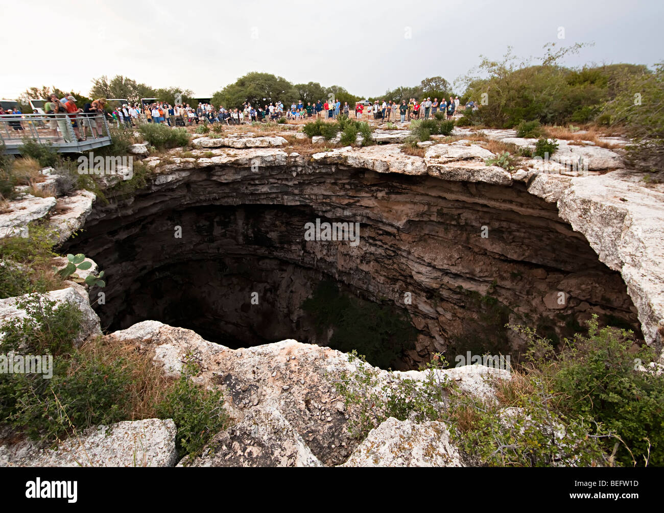 The Devil's Sinkhole Texas USA with people gathered to view bat flight Stock Photo