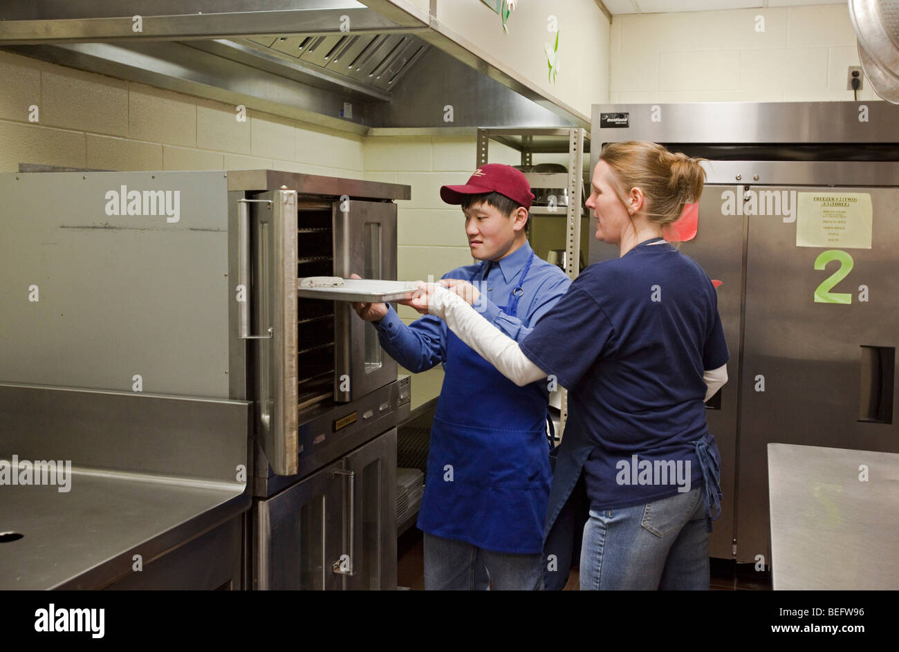 Developmentally Disabled Students in Food Preparation Class at Public School Stock Photo