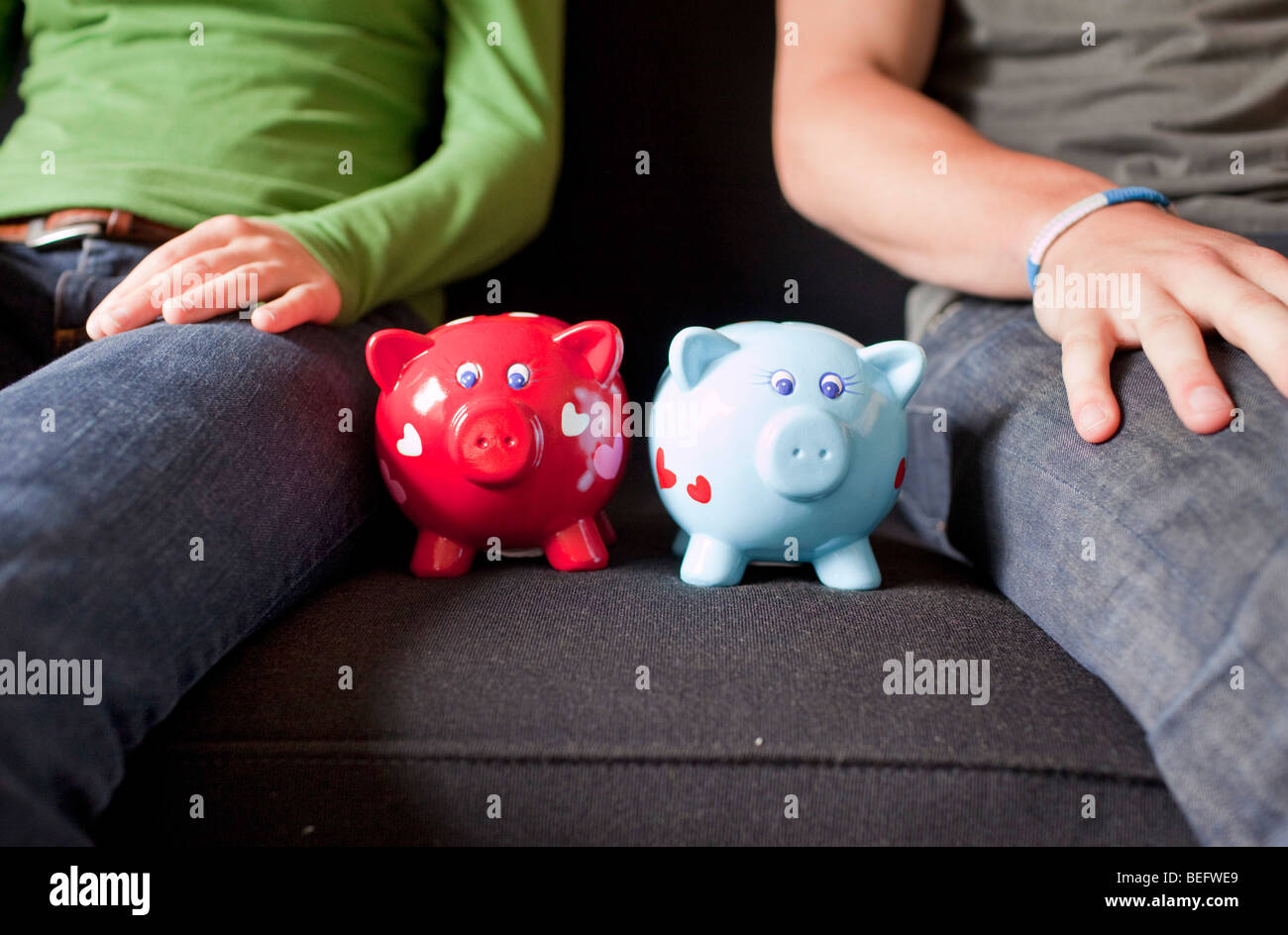 Young couple with piggy banks Stock Photo