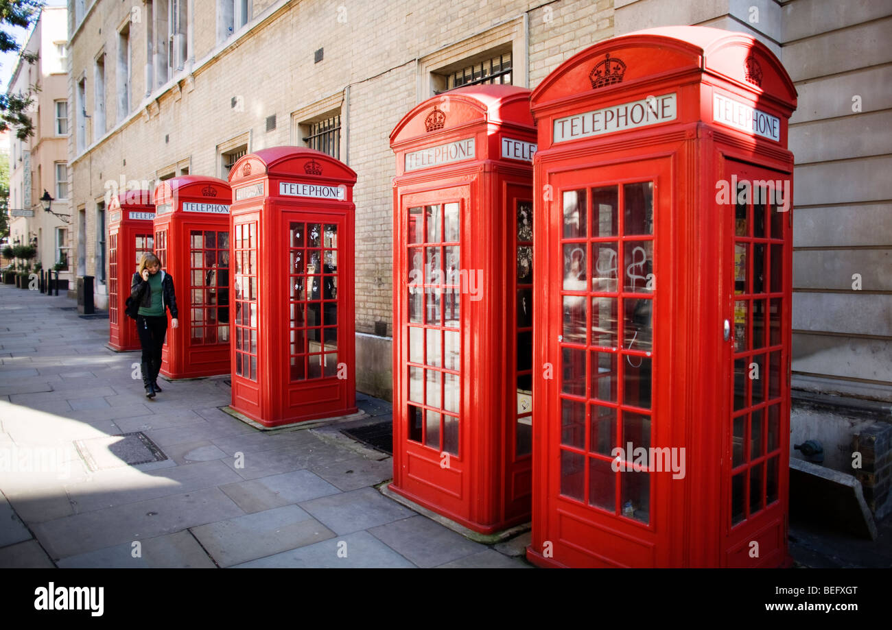 Five British red phone boxes in a row near Covent Garden in central London, UK Stock Photo