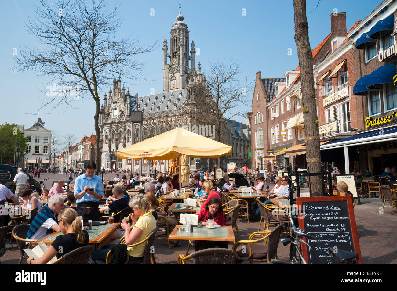 A street cafe at the market square in front of the late-Gothic town hall of Middelburg. Stock Photo