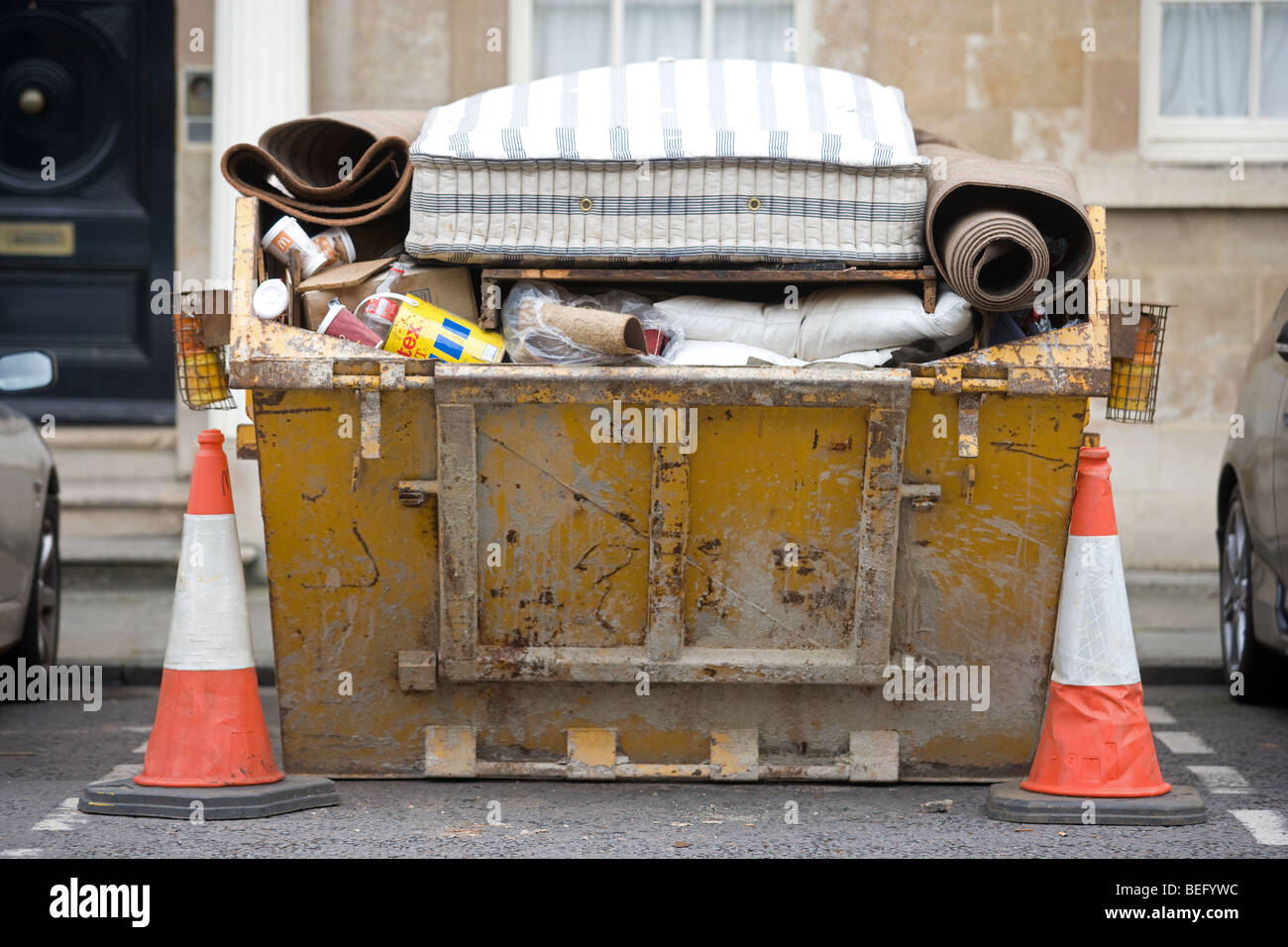 Builders Skip Parked In A Car Parking Space Stock Photo