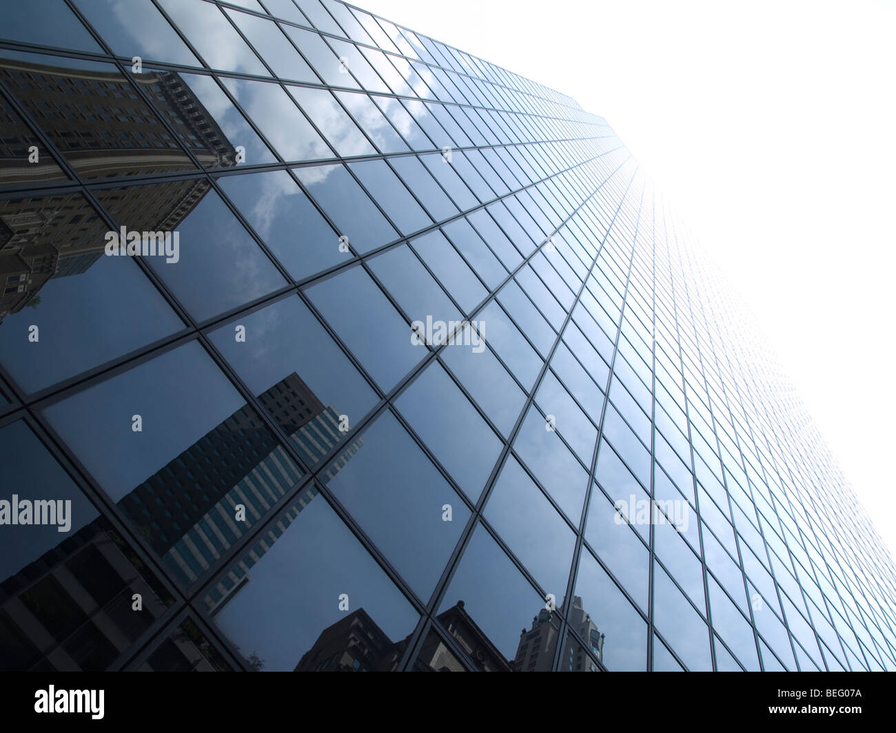 High modern skyscrapers on a background of a bright sky and clouds. Stock Photo