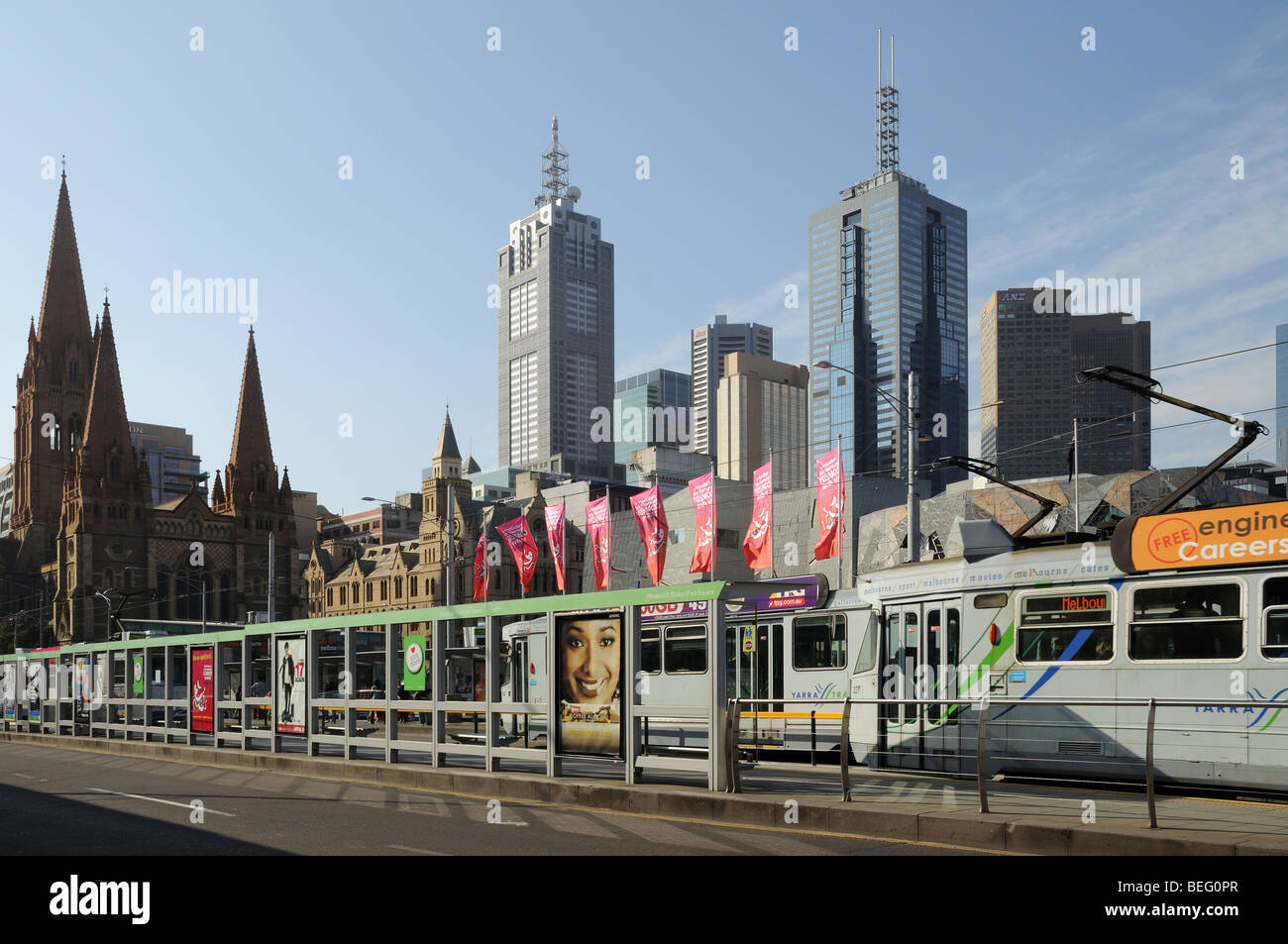Trams and tram stop on Princes Bridge over Yarra River Melbourne Australia with St Pauls Cathedral and high rise skyscrapers Stock Photo