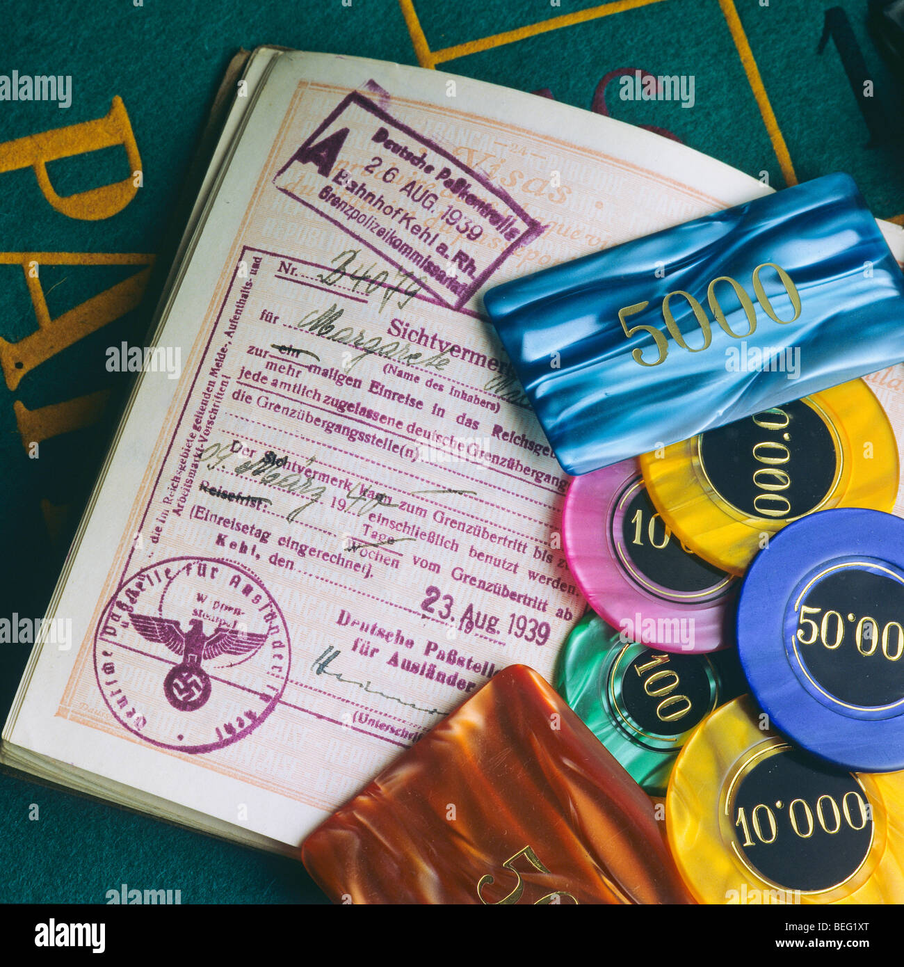 Vintage French passport with August 1939 German visa and gambling chips Stock Photo