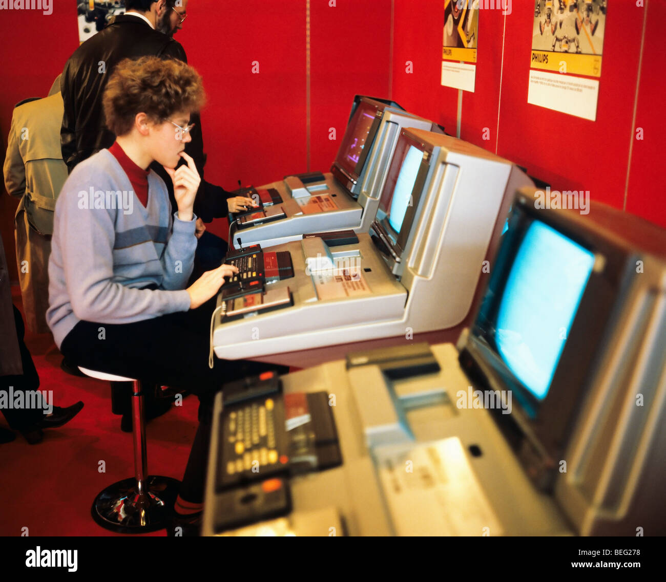 1980s Teen playing computer games, vintage computer playstations exhibition, Paris, France, Europe Stock Photo