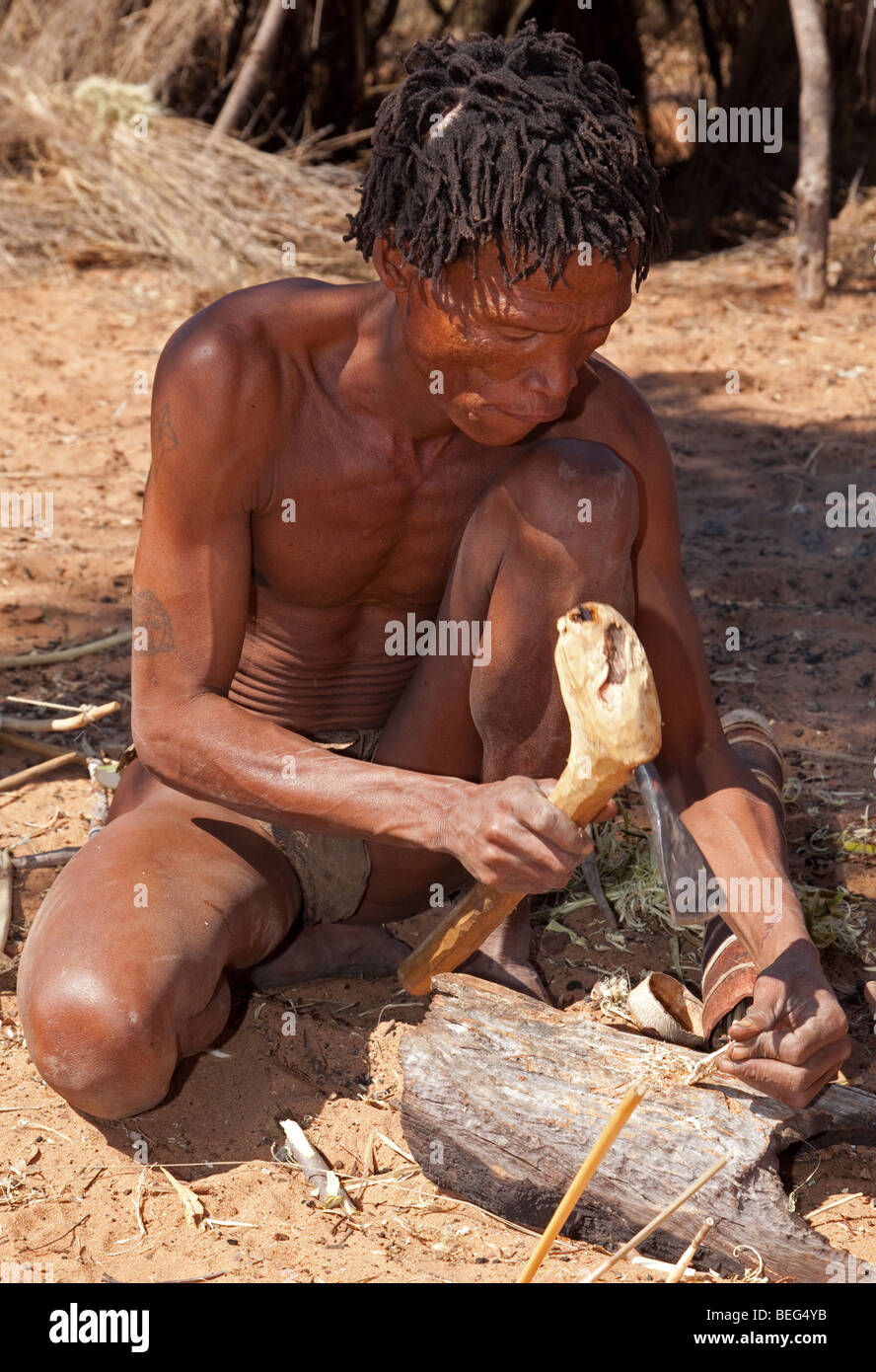 San Village. Manufacturing a bow and arrow the traditional way. Stock Photo