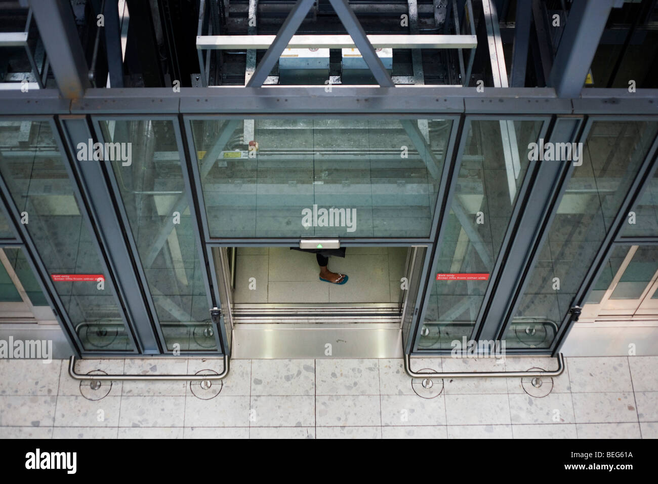 Heathrow Express lift passenger's foot and architecture at Heathrow airport's terminal 5. Stock Photo