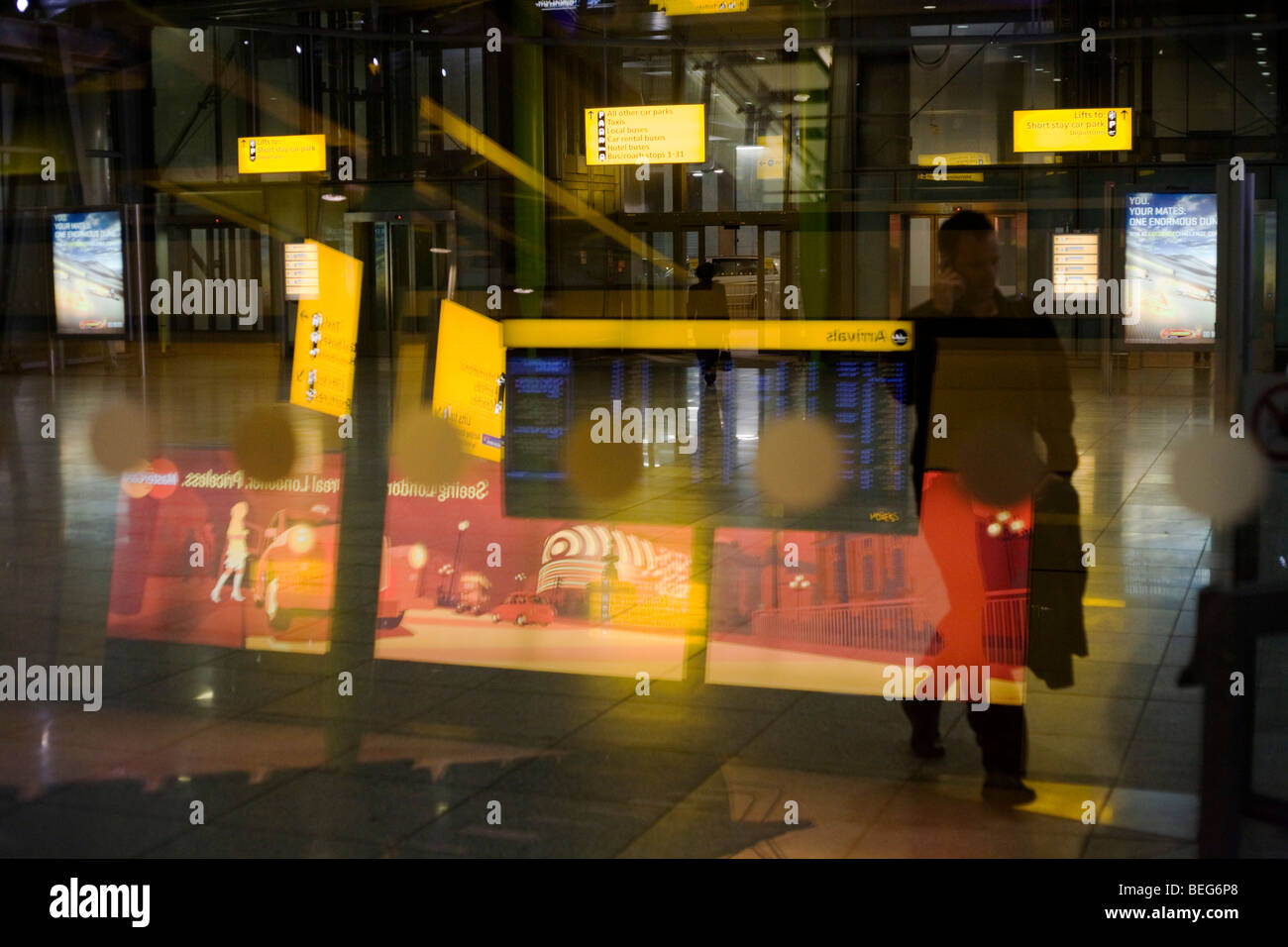 Evening sign and architecture atmosphere seen through large window glass at Heathrow's terminal 5. Stock Photo