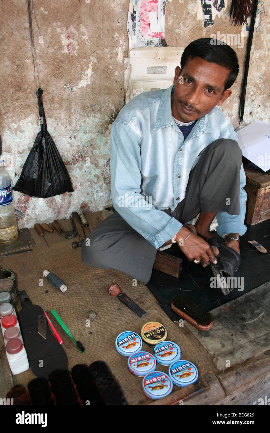 Indian Shoeshiner On The Street In Diphu, Assam State Stock Photo