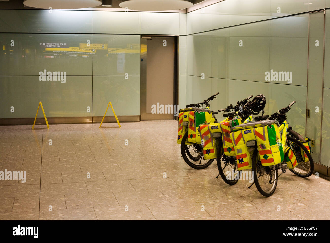 NHS Paramedic Responders' Specialized Rockhopper mountain bikes are propped up in Arrivals concourse at Heathrow's T5. Stock Photo