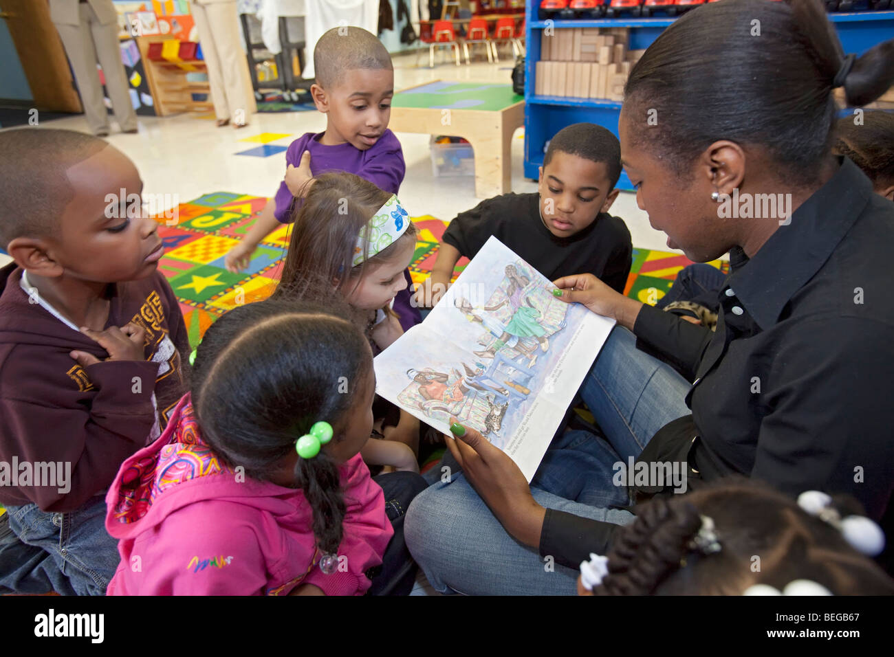Detroit, Michigan - A teacher reads a book to children at the World of Wonders Child Care Center. Stock Photo