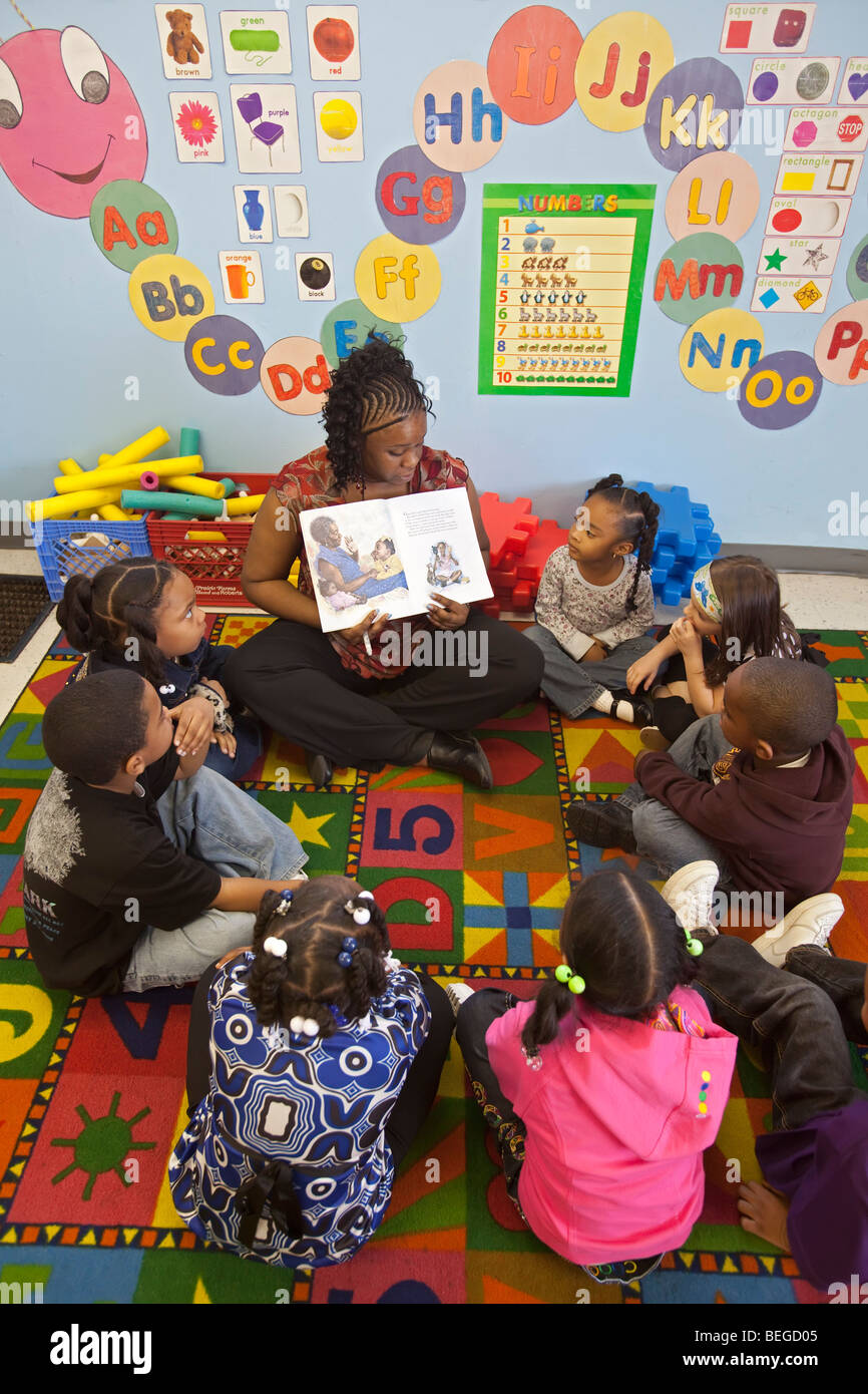 Detroit, Michigan - A teacher reads a story to children at the World of Wonders Child Care Center. Stock Photo