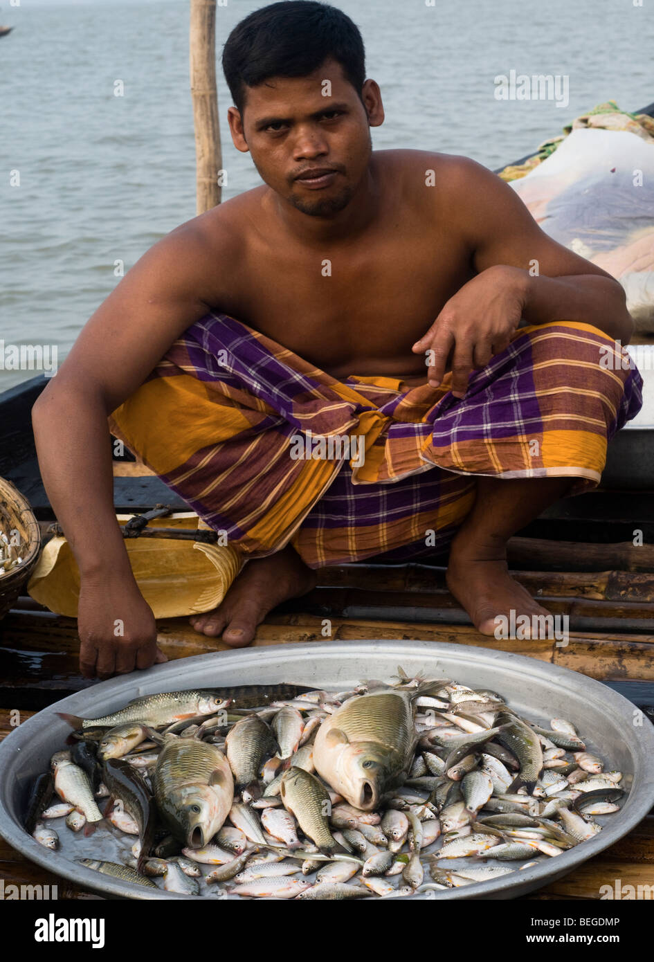 Fisherman sorting fishes to sell in the market Stock Photo