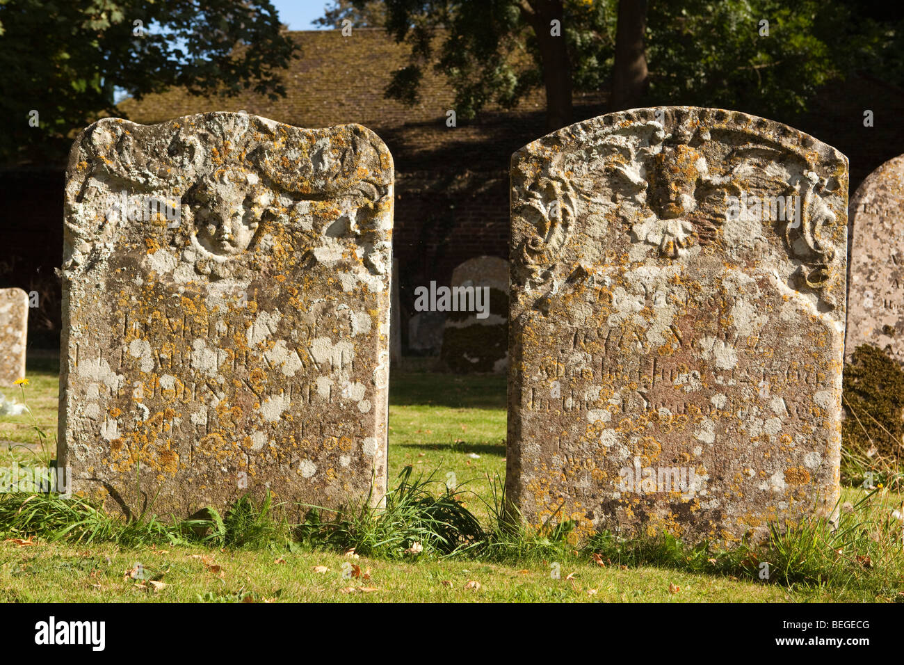 England, Cambridgeshire, Hemingford Grey, St James’ Church, two old headstones in churchyard Stock Photo