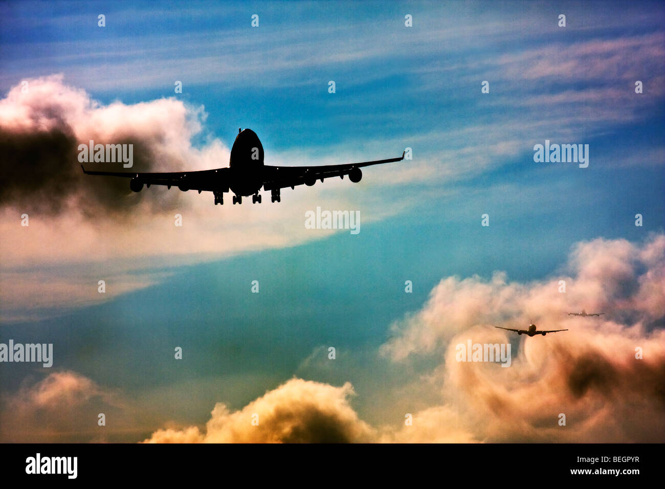 Wake turbulence forms behind aircrafts as they passes through the clouds when descending for landing. Stock Photo