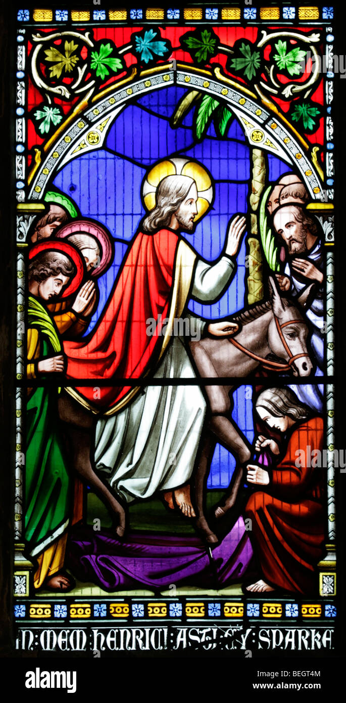 A stained glass window by William Warrington depicting Jesus entering Jerusalem on a donkey, Church of St Mary the Virgin, Gunthorpe, Norfolk Stock Photo