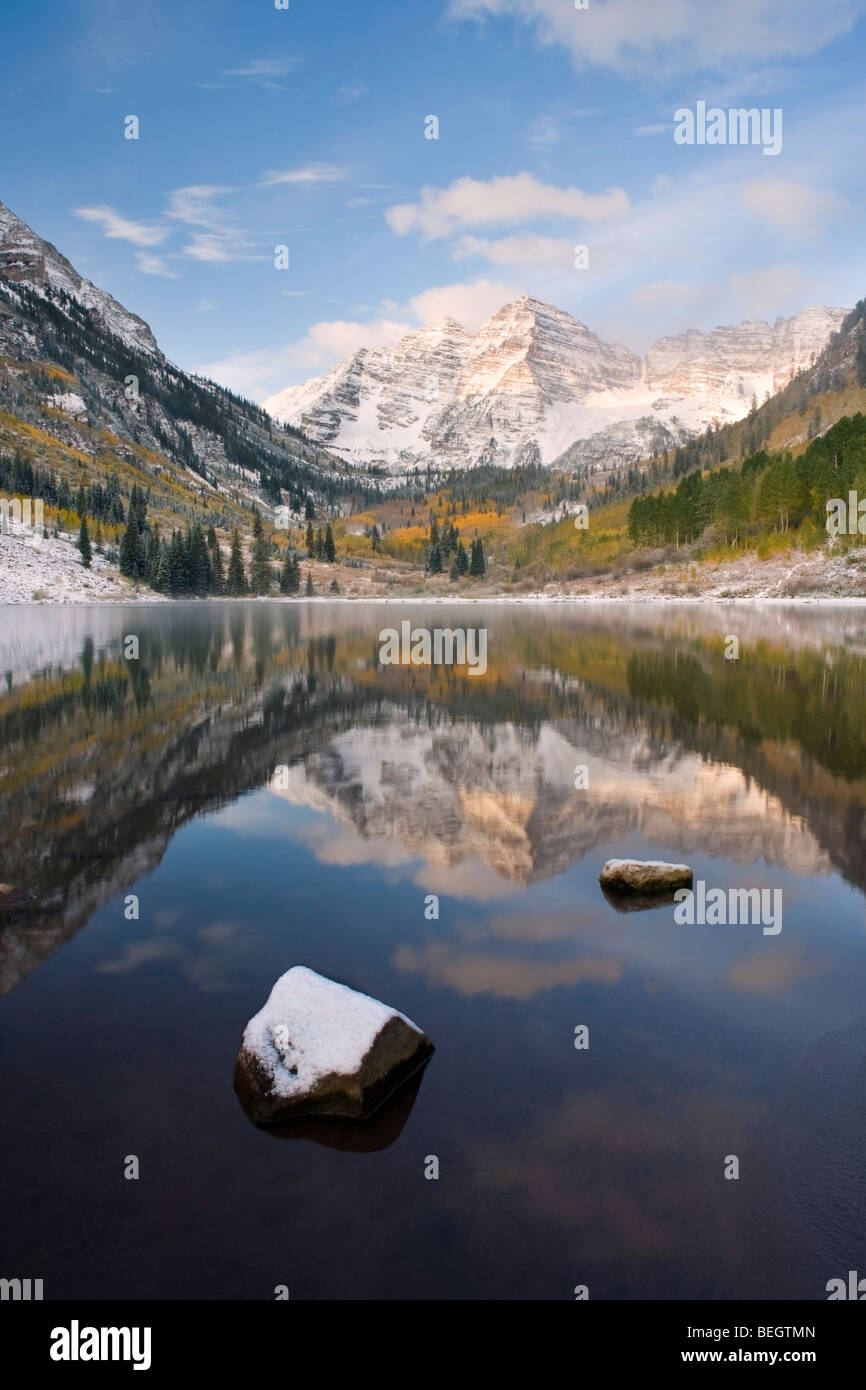 Maroon Bells Reflection during fall or winter with frozen lake, ice and snow Stock Photo