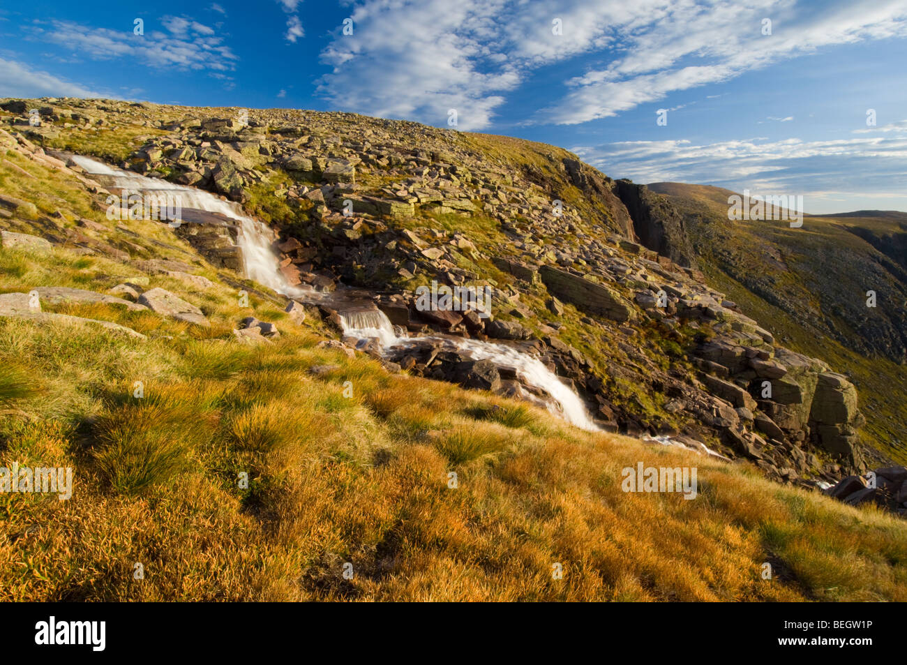 Waterfalls on the Allt Feithe Buidhe stream, Cairngorm plateau. The russet-coloured tussocks in the foreground are Deer Grass Stock Photo