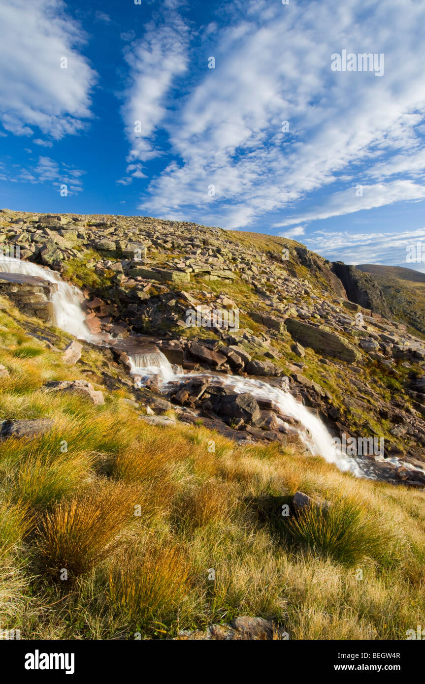 Waterfalls on the Allt Feithe Buidhe stream, Cairngorm plateau. The russet-coloured tussocks in the foreground are Deer Grass Stock Photo