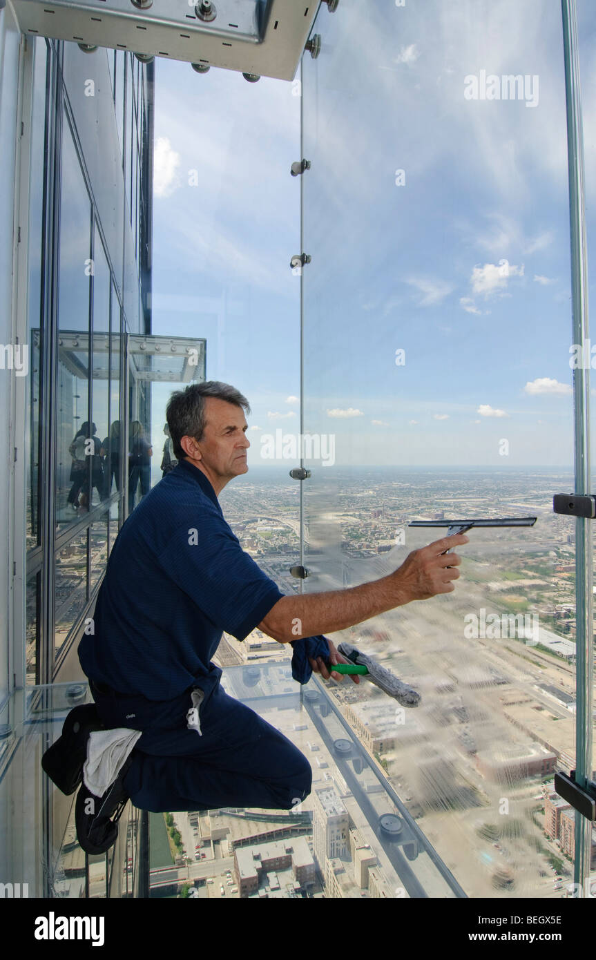 Window cleaner at the Ledge, Sears Tower, Chicago USA.  At 1,353 feet this is a job needing a head for heights Stock Photo