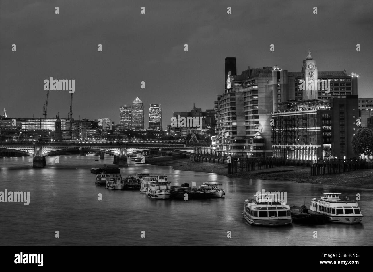 Oxo Cafe on the Southbank and Docklands viewed at night from Waterloo Bridge in London England. Stock Photo