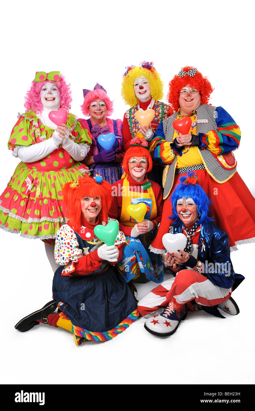 Group of clowns holding hearts isolated over a white background Stock Photo Alamy
