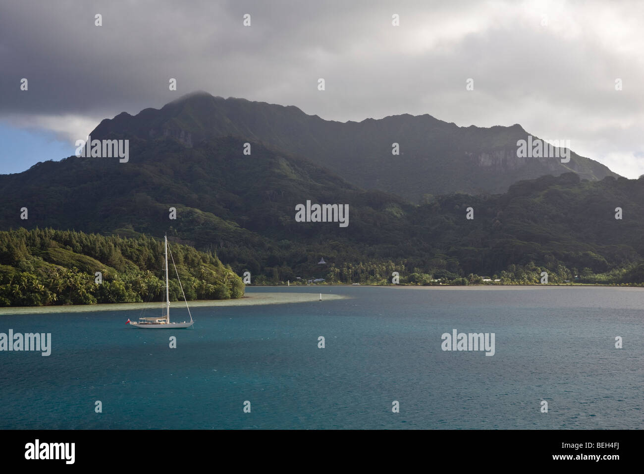 Yacht lies in Lagoon at anchor, Huahine Atoll, French Polynesia Stock Photo