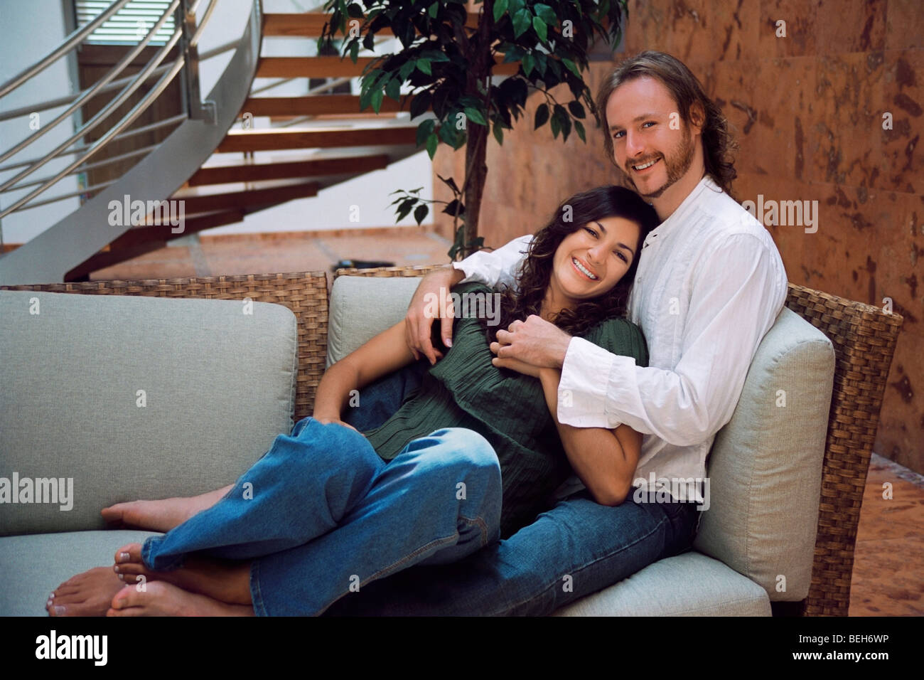 Portrait of a mid adult woman lying on the lap of a young man and ...