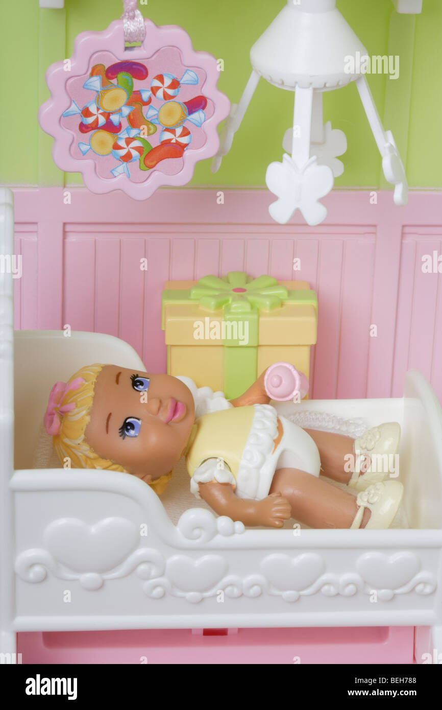 Baby girl doll in her cot Stock Photo Alamy