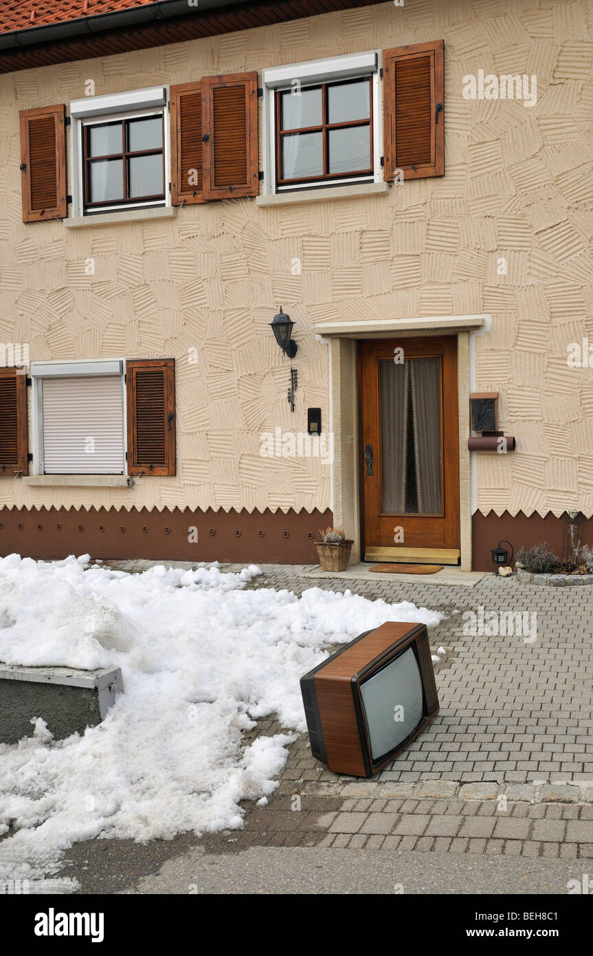 Old CRT Television set standing in front of a house Stock Photo