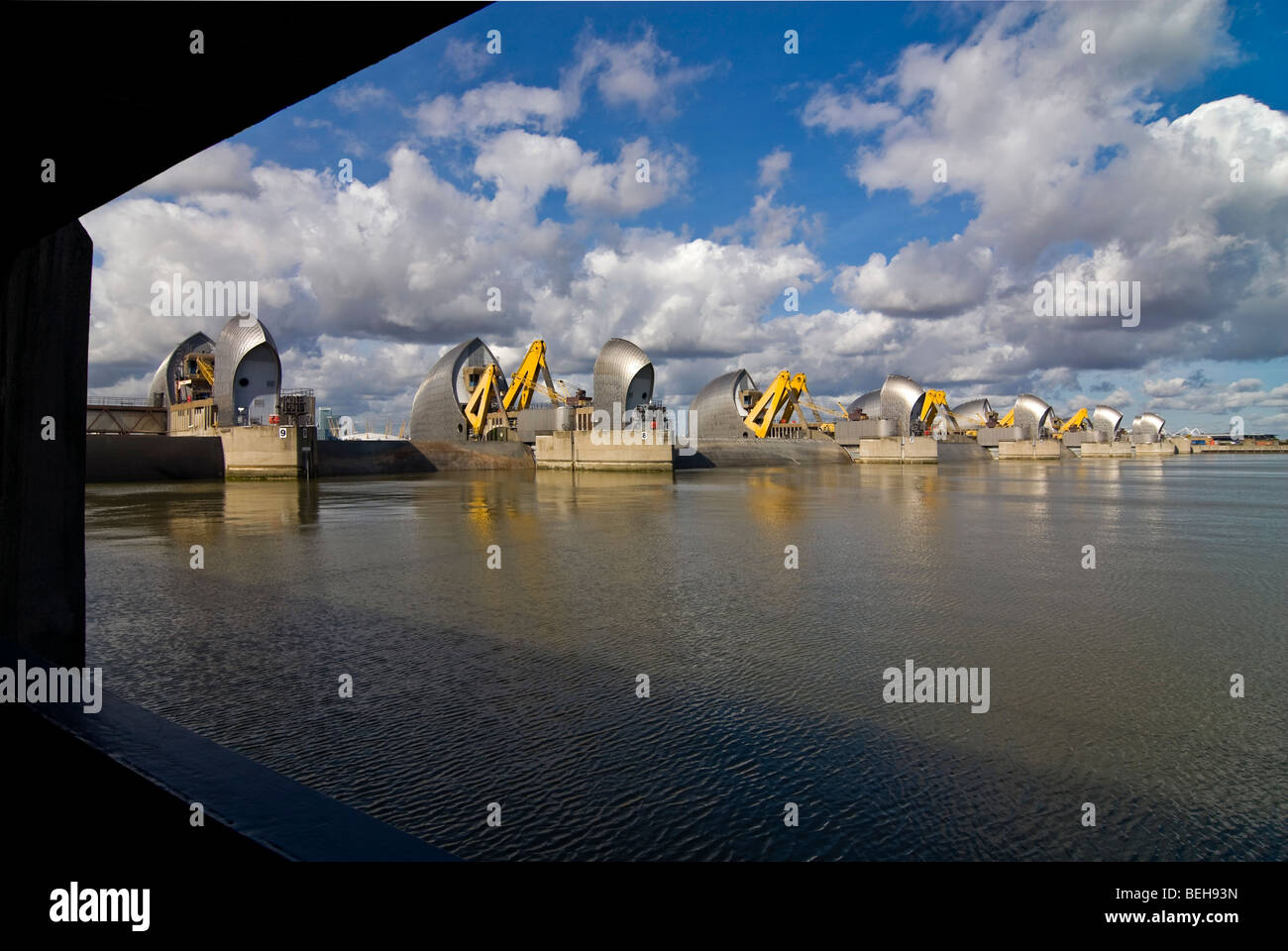 Horizontal downstream wide angle of the Thames Flood Barrier closed for maintenance work in London on a bright sunny day. Stock Photo