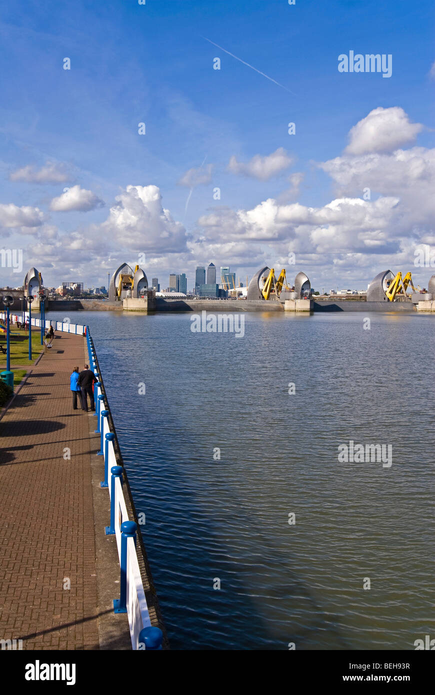 Vertical wide angle of the Thames Flood Barrier with views across to Canary Wharf and the O2 in central London on a sunny day Stock Photo