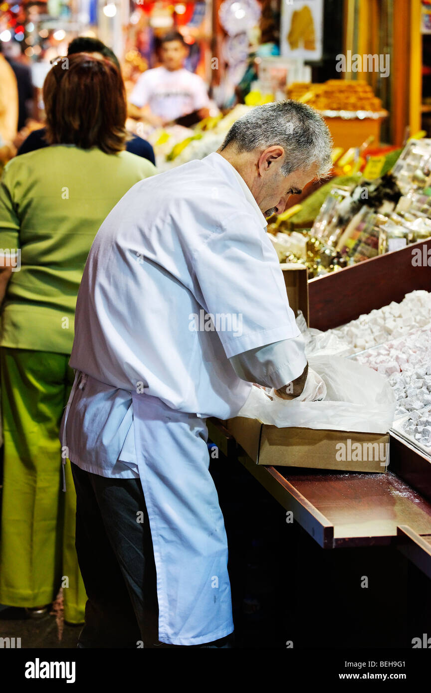 Turkish Shopkeeper A shopkeeper replenishes his display of lokum (Turkish Delight) in ...