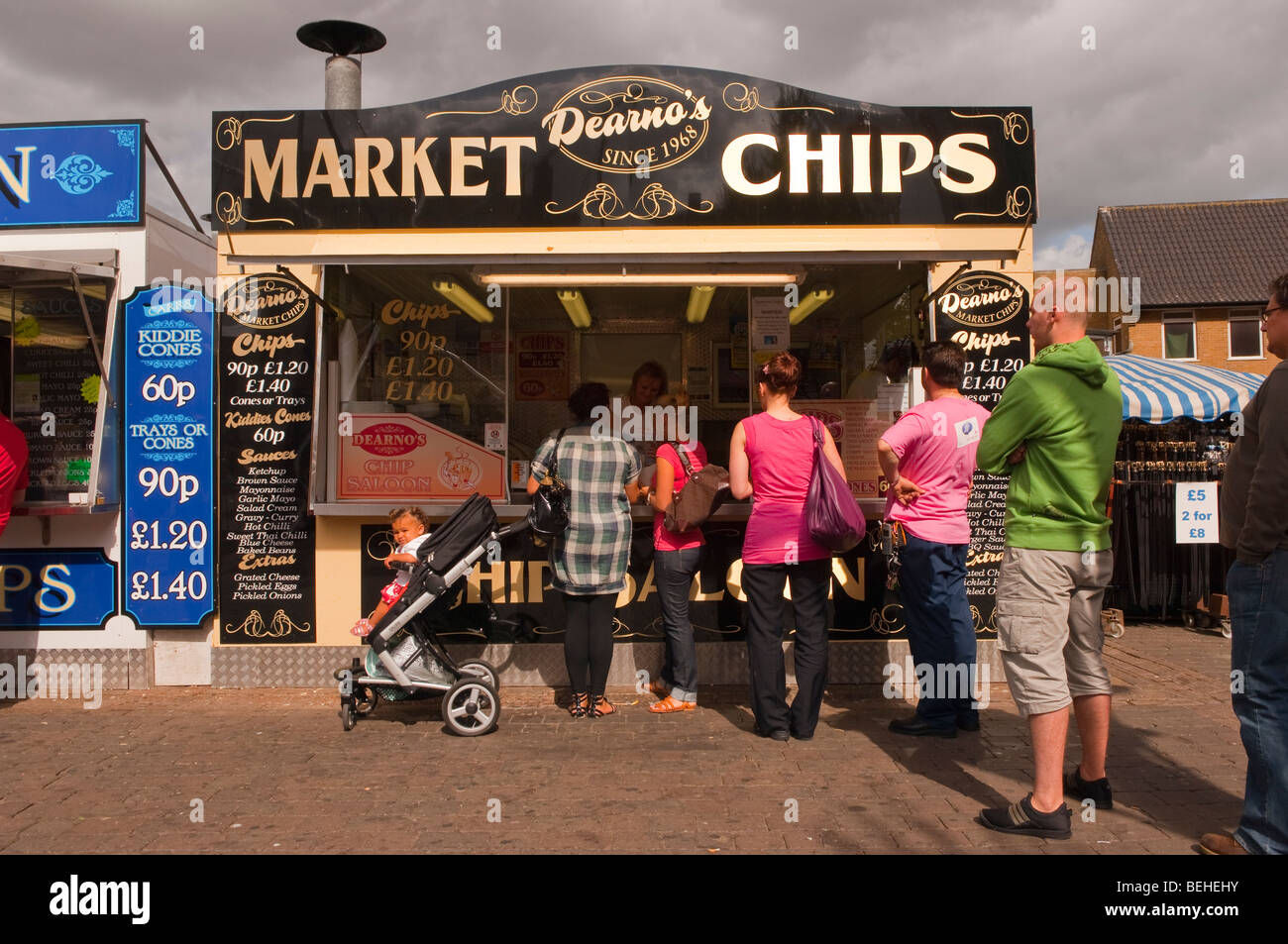 People eating chips from a chip stall at the market in Great Yarmouth