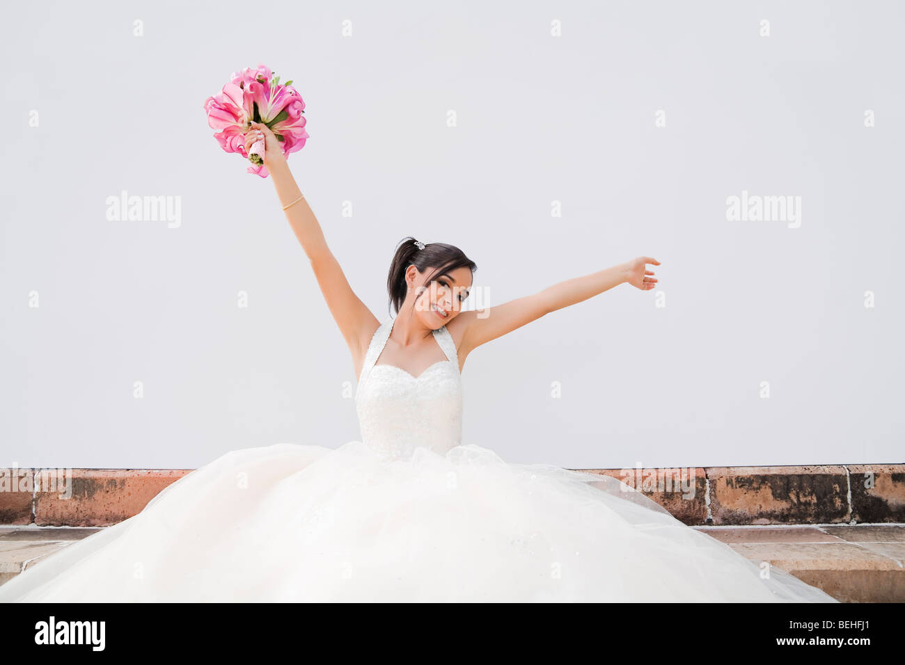 Teenage girl holding bunch of flowers and smiling Stock Photo - Alamy