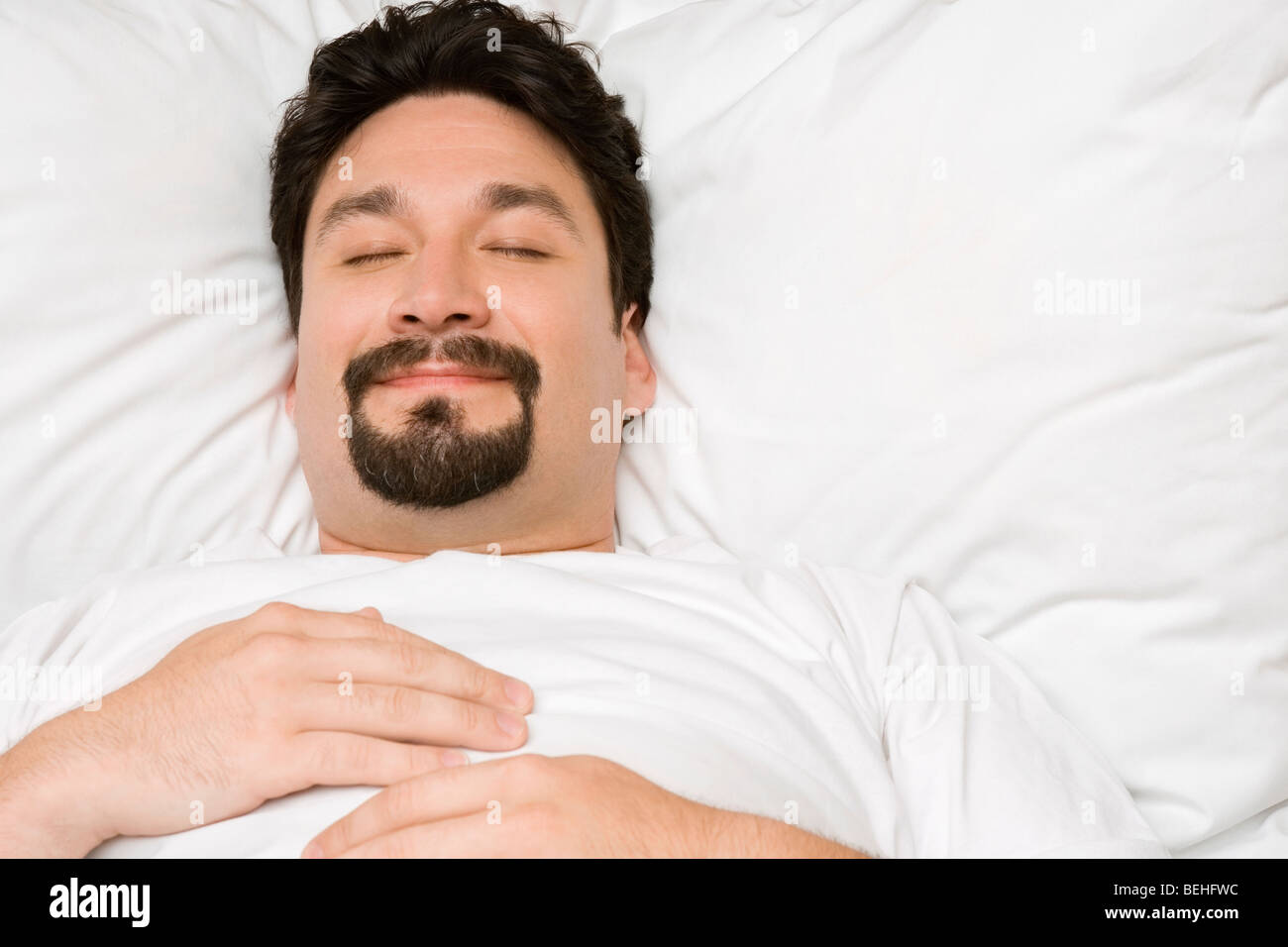 Close-up of a mid adult man sleeping on the bed Stock Photo - Alamy