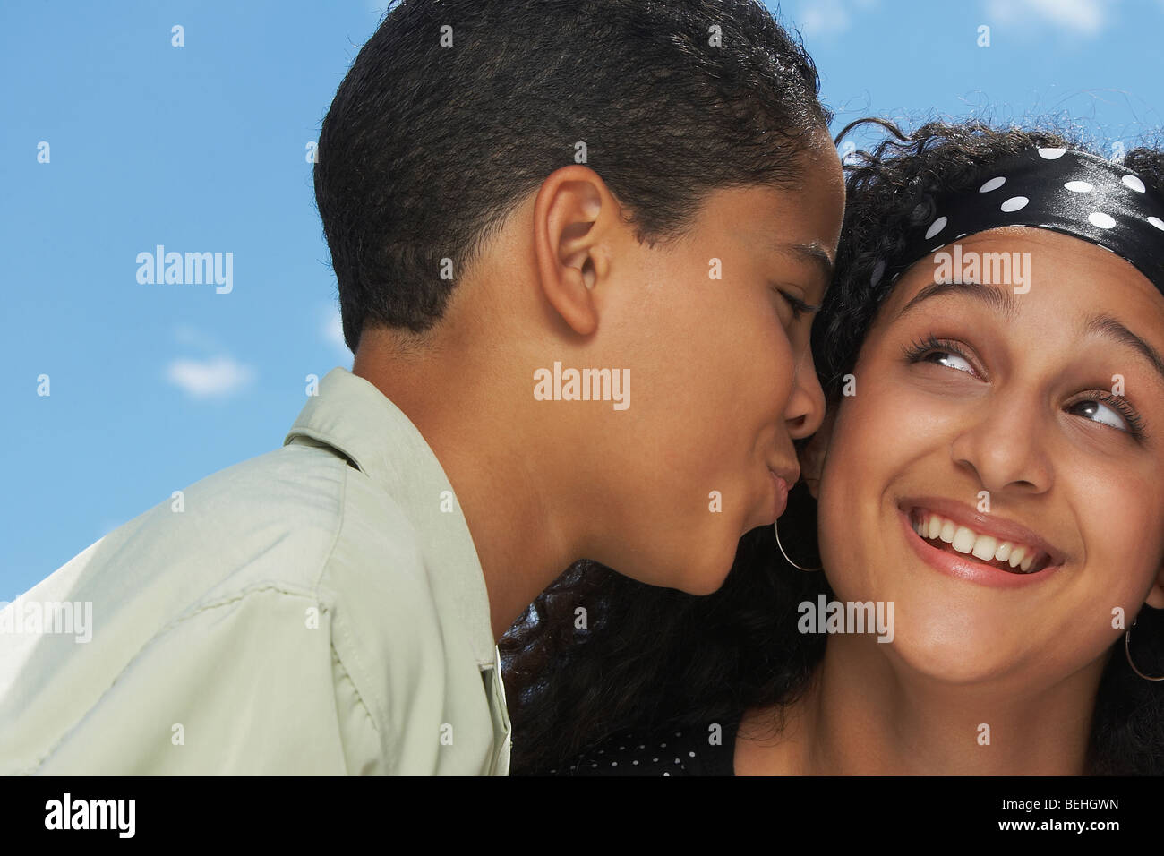 Side profile of a boy kissing a teenage girl Stock Photo