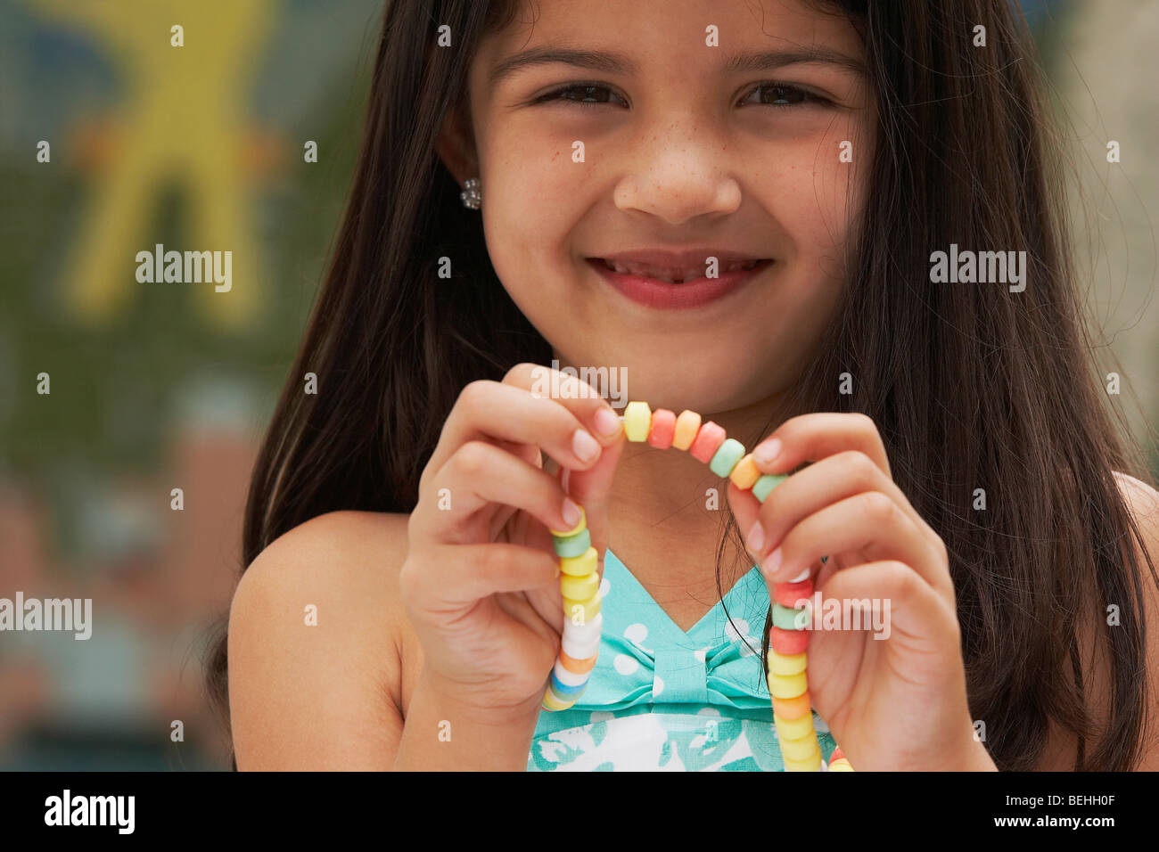 Portrait of a girl showing a candy necklace Stock Photo