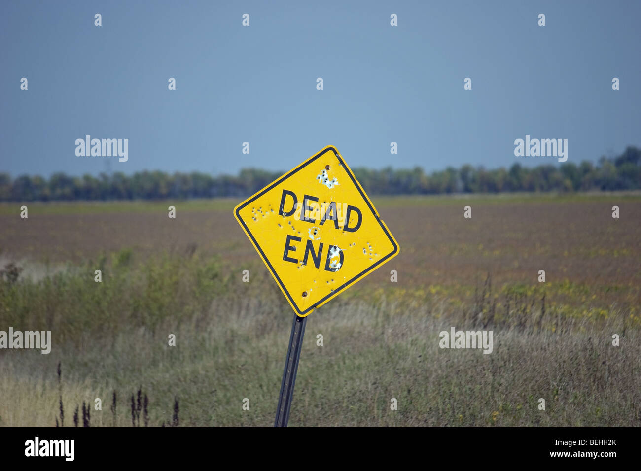 bent dead end sign with bullet holes Stock Photo