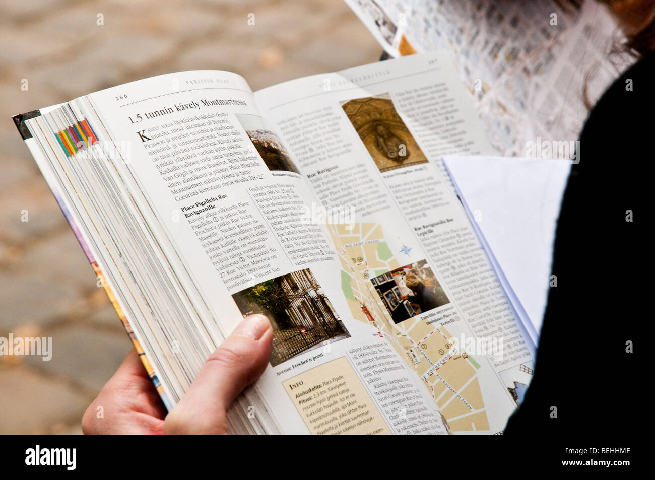 Reading a travel book on journey in Montmartre, Paris, France. Stock Photo