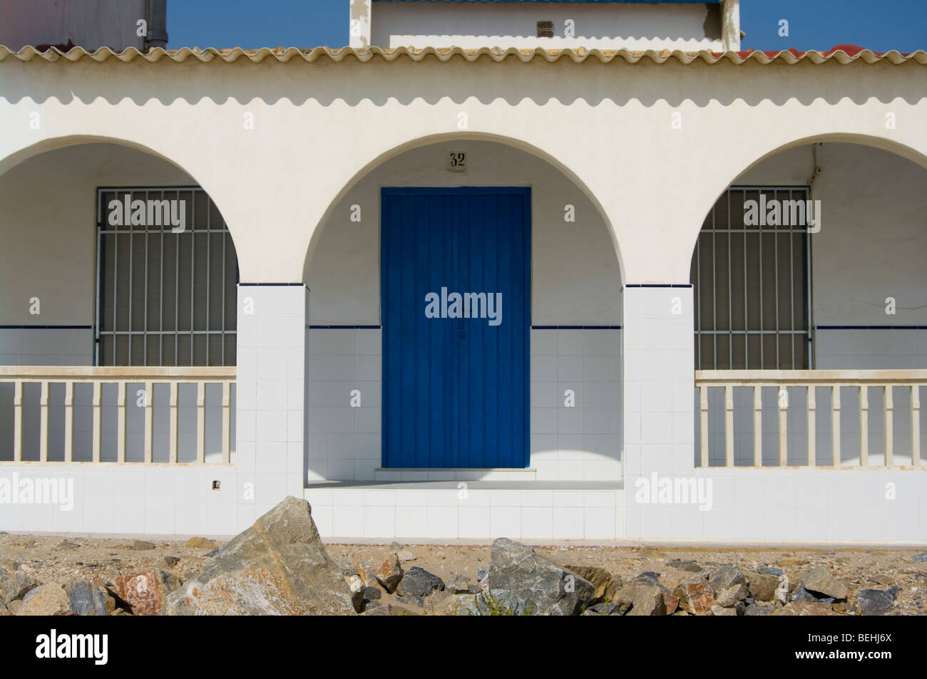 White Walled Holiday Beachfront Villa With A Bright Blue Wooden Door Playa Del Pinet La Marina Spain Stock Photo