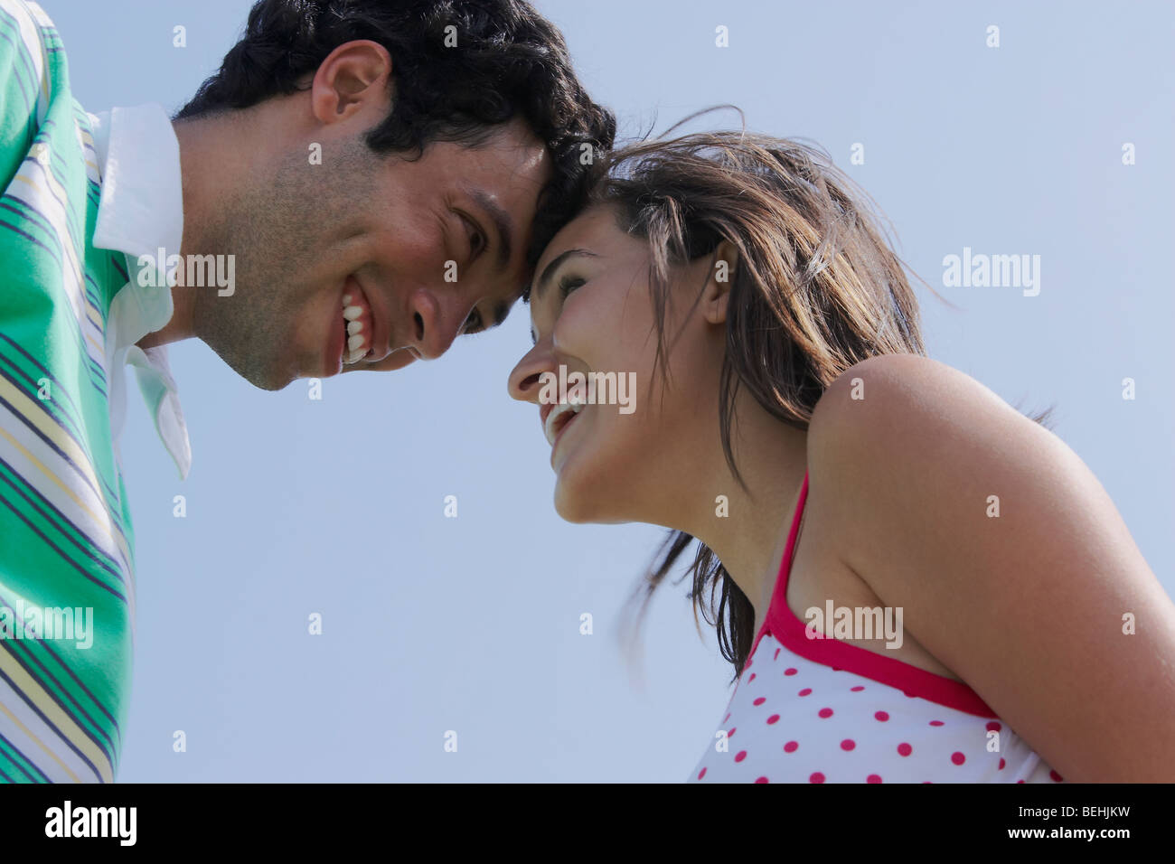 Side profile of a young couple looking at each other and smiling Stock ...